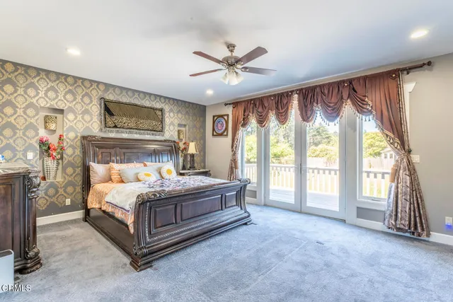 a bedroom with a large bed and a tv