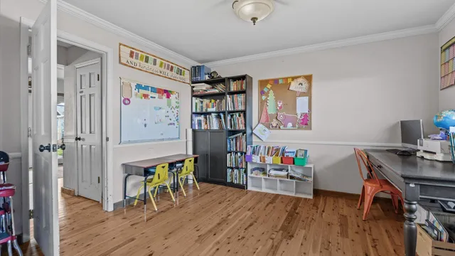 a view of a workspace with furniture and wooden floor