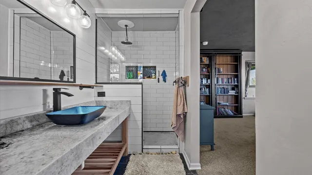 a bathroom with a tub sink and mirror