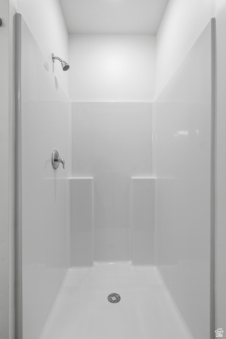 2085 North Main Street, Unit 306 Sunset, UT 84015 - Photo 15 of 18 White shower enclosure with integrated shelving, chrome fixtures, and a ceiling-mounted showerhead
