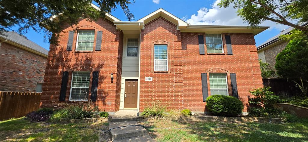 2820 Deer Ridge Drive Rockwall, TX 75032 - Photo 1 of 36 Brick exterior with multiple windows, architectural shutters, and a front entry door