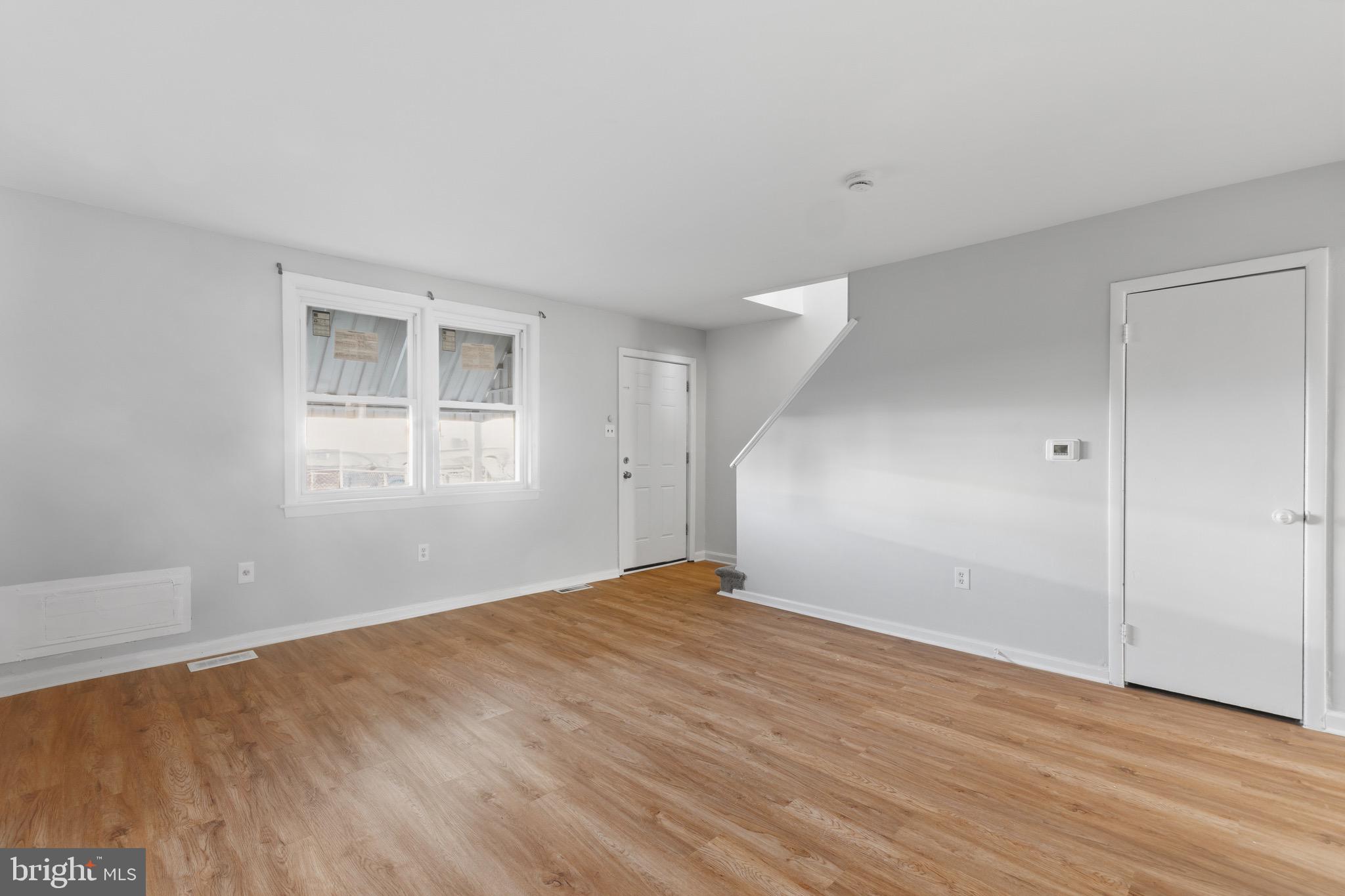129 Brown Street Mount Holly, NJ 08060 - Photo 3 of 19 a view of empty room with wooden floor and fan