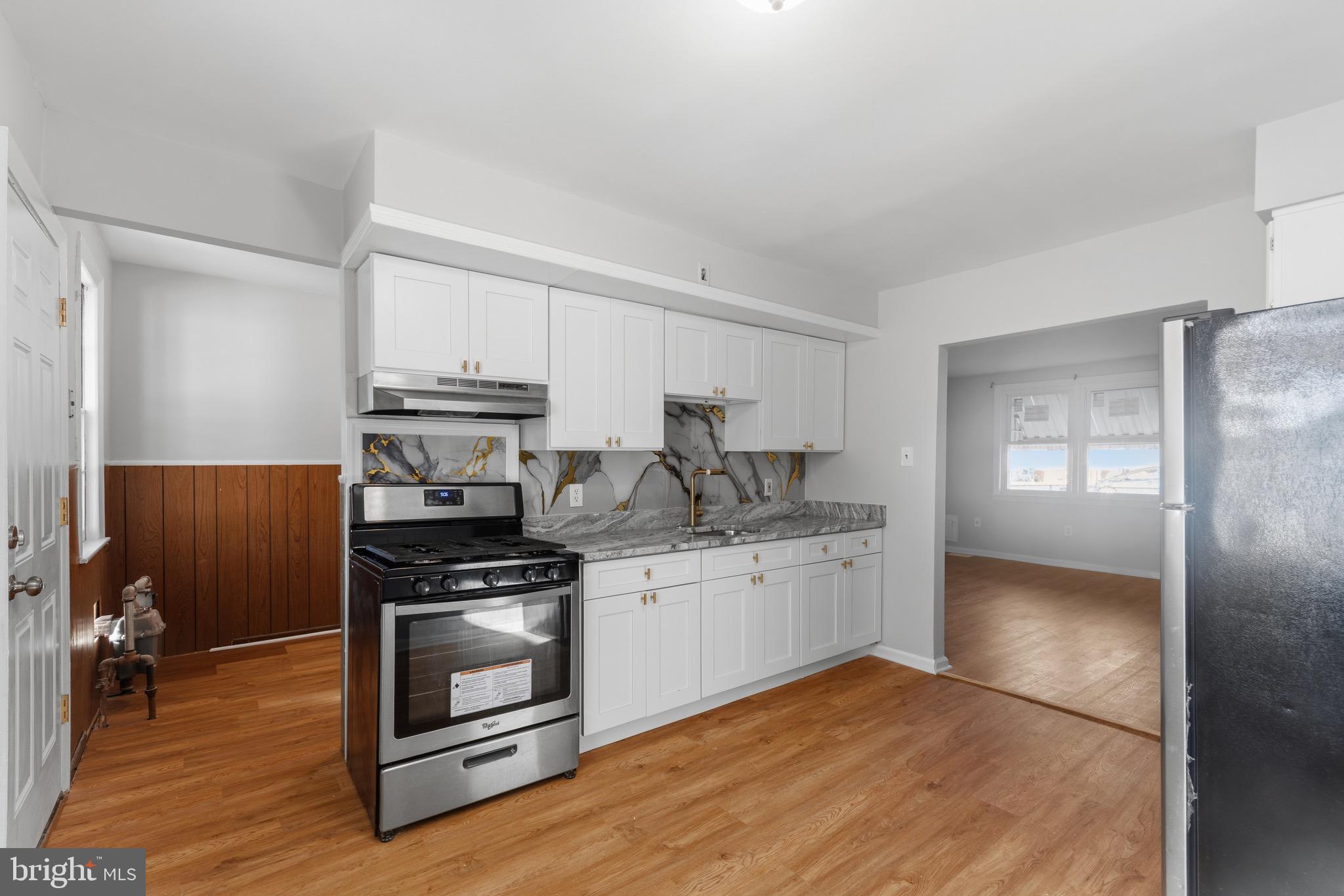 129 Brown Street Mount Holly, NJ 08060 - Photo 6 of 19 a kitchen with a stove and a refrigerator