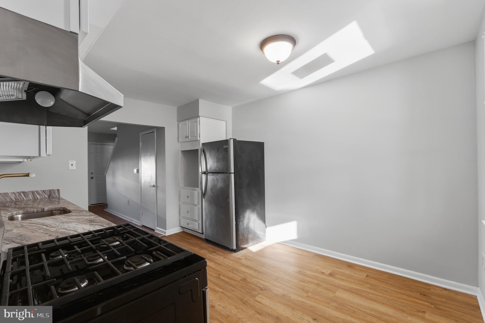 129 Brown Street Mount Holly, NJ 08060 - Photo 7 of 19 a kitchen with a stove and a refrigerator