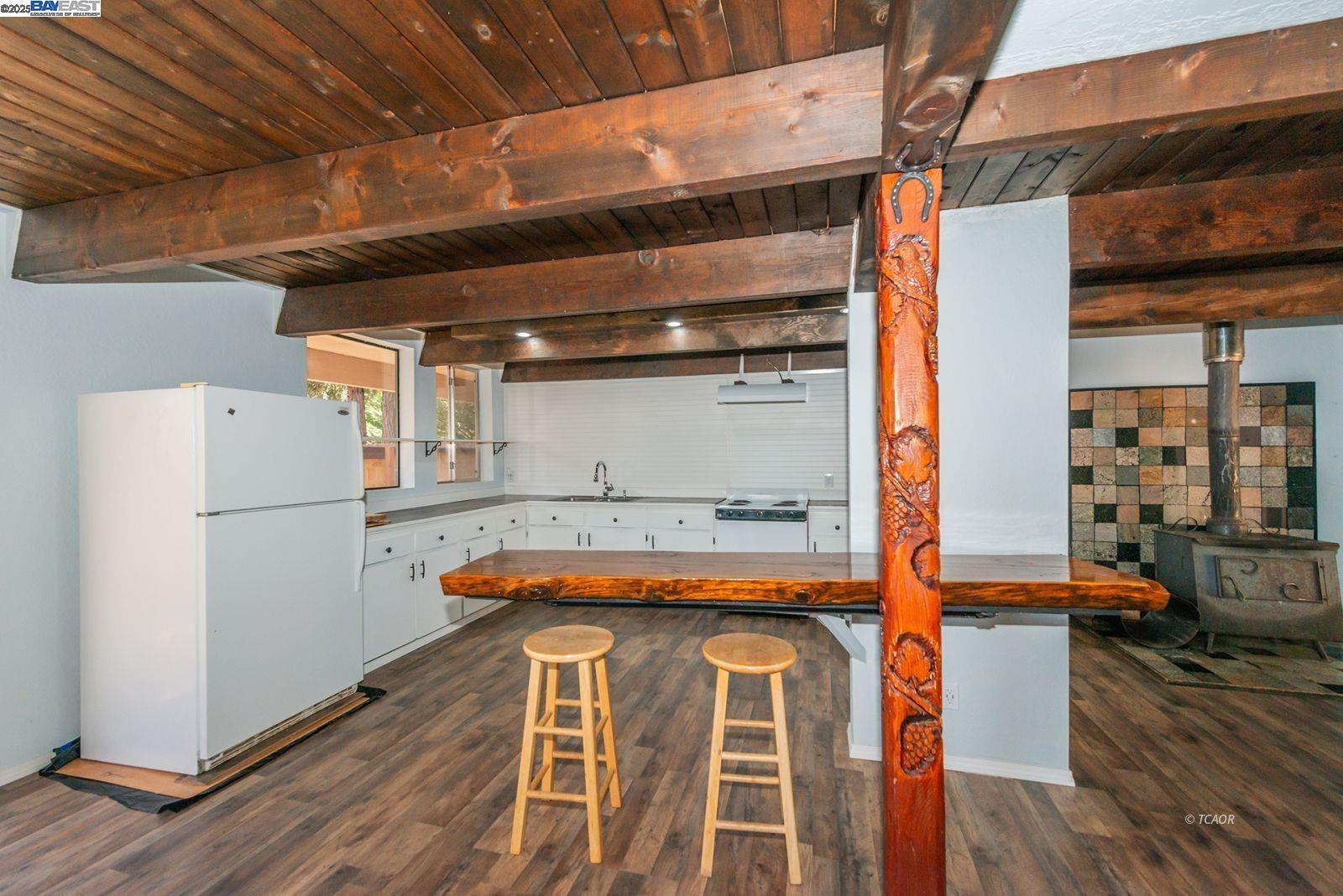 230 Mary Avenue Trinity Center, CA 96091 - Photo 11 of 46 a kitchen with a refrigerator and wooden floor