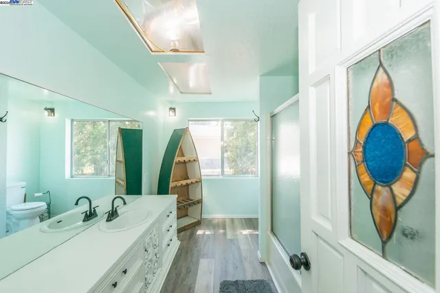 a en suite bathroom with a sink and a large mirror