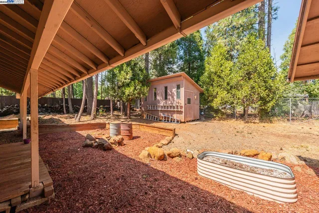 a view of a house with backyard and sitting area