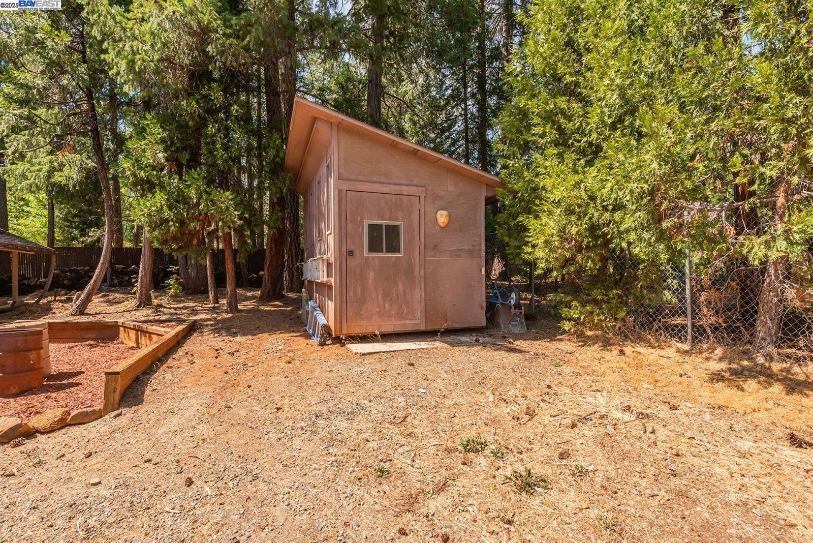 230 Mary Avenue Trinity Center, CA 96091 - Photo 40 of 46 a backyard of a house with large trees and covered with wooden fence