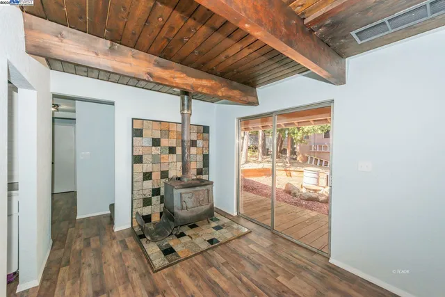 a view of a hallway with wooden floor and city view