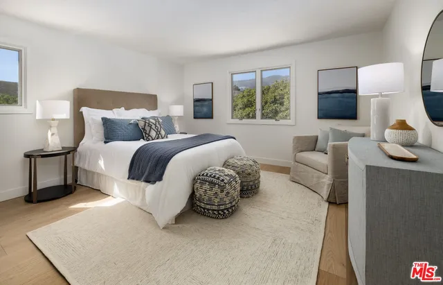 a spacious bedroom with a bed and a couch