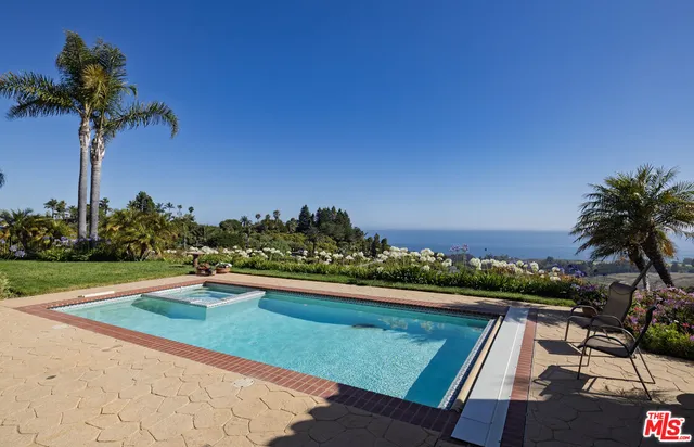 a view of swimming pool with a yard
