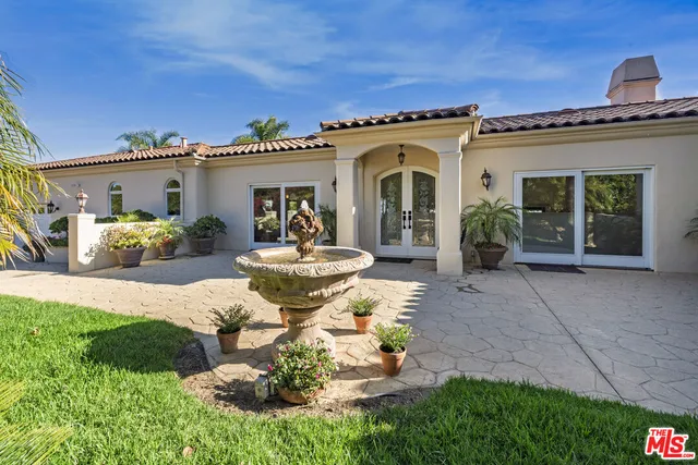 a view of a house with backyard outdoor seating and hardwood floor