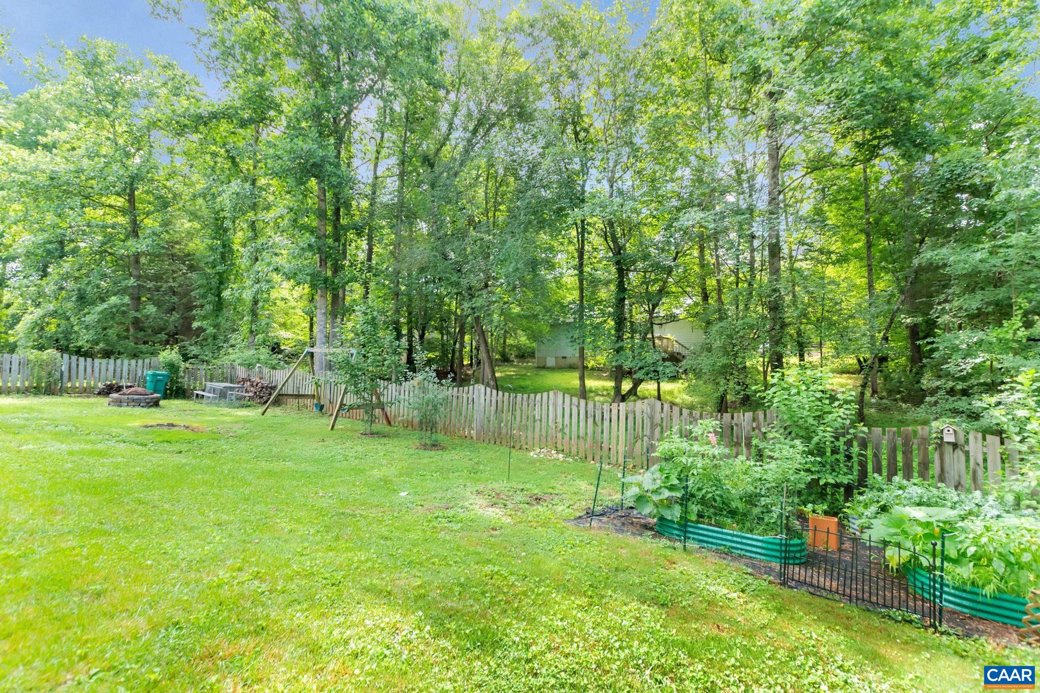 33 Begum Road Palmyra, VA 22963 - Photo 54 of 62 a backyard of a house with plants and large trees