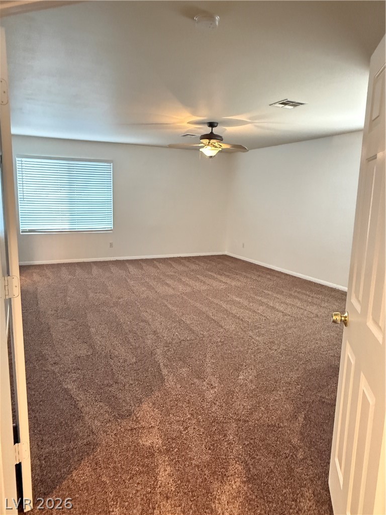 10975 Calcedonian Street Las Vegas, NV 89141 - Photo 22 of 25 This cozy bedroom features plush carpeting and a bright window, creating a serene personal retreat.