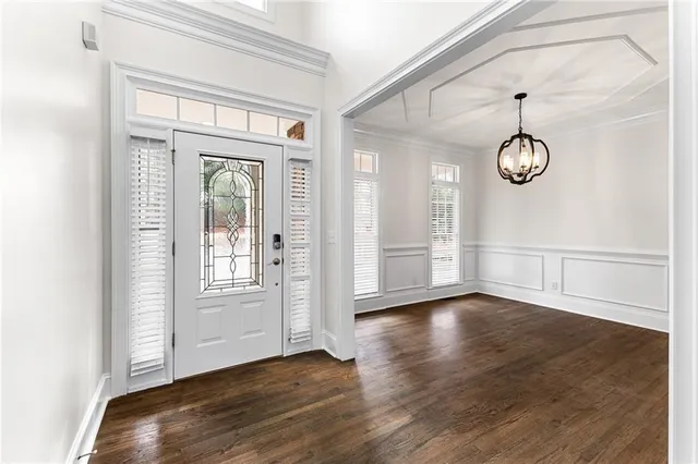 a view of a room with wooden floor and window