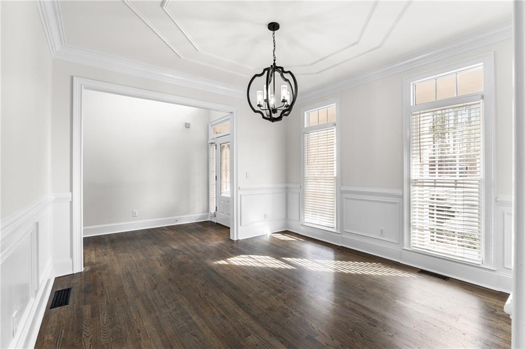 8805 Saddle Trail Ball Ground, GA 30107 - Photo 13 of 53 a view of an empty room with wooden floor and a window