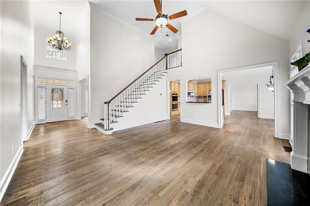 8805 Saddle Trail Ball Ground, GA 30107 - Photo 16 of 53 a view of a livingroom with wooden floor and stairs
