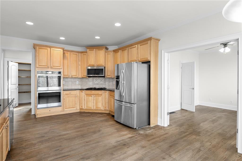 8805 Saddle Trail Ball Ground, GA 30107 - Photo 22 of 53 a kitchen with stainless steel appliances granite countertop a refrigerator and a stove top oven