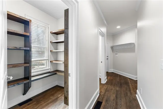a view of an empty room and wooden floor