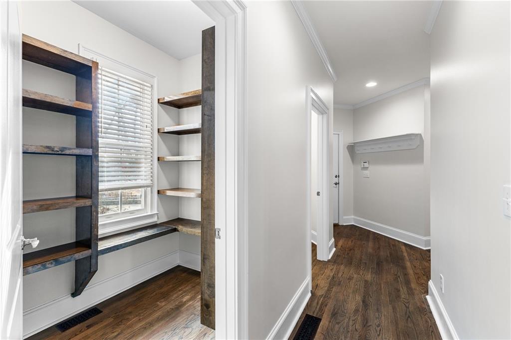 8805 Saddle Trail Ball Ground, GA 30107 - Photo 25 of 53 a view of a hallway with wooden floor and a kitchen