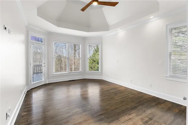 a view of an empty room with wooden floor