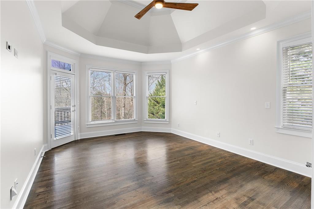8805 Saddle Trail Ball Ground, GA 30107 - Photo 29 of 53 an empty room with wooden floor and windows