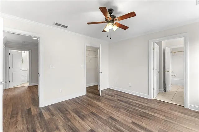 a spacious bathroom with a granite countertop sink mirror and a bathtub