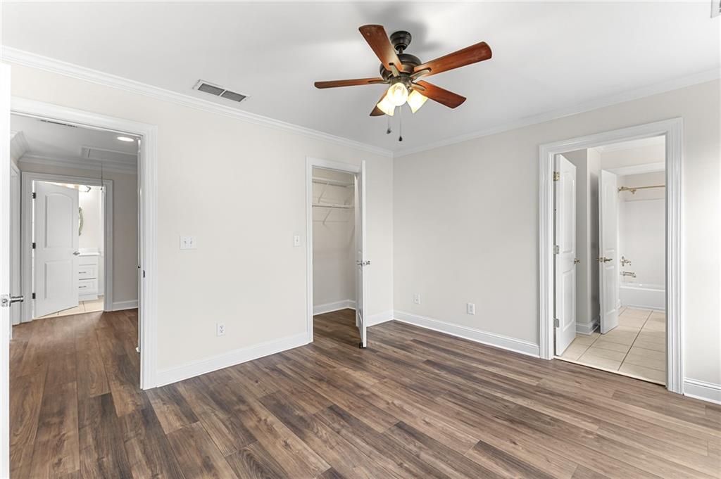 8805 Saddle Trail Ball Ground, GA 30107 - Photo 38 of 53 an empty room with wooden floor and a ceiling fan