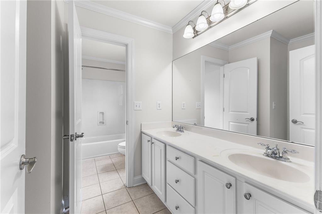 8805 Saddle Trail Ball Ground, GA 30107 - Photo 39 of 53 a spacious bathroom with a granite countertop sink mirror and a bathtub