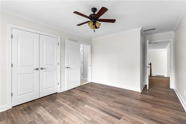 a view of a hallway view with wooden floor and staircase
