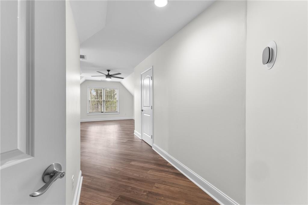 8805 Saddle Trail Ball Ground, GA 30107 - Photo 42 of 53 a view of a hallway view with wooden floor and staircase