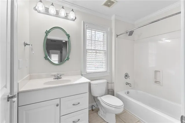 an empty room with wooden floor chandelier fan and windows
