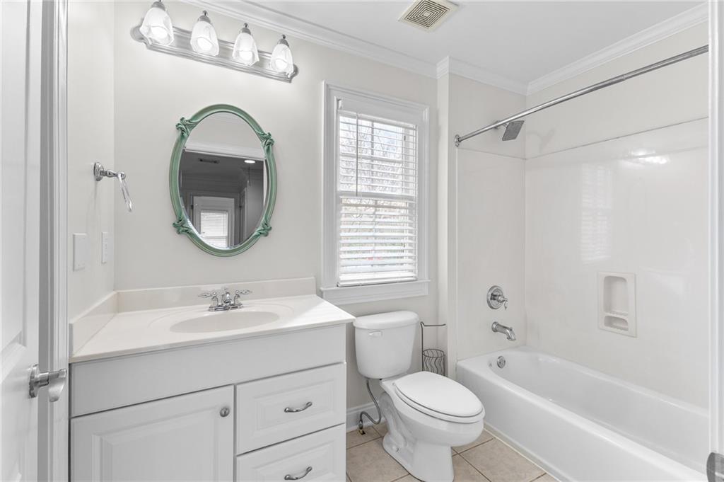 8805 Saddle Trail Ball Ground, GA 30107 - Photo 45 of 53 a bathroom with a sink a toilet and a mirror