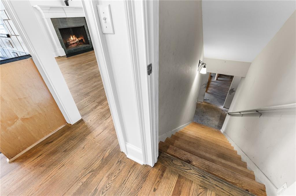 8805 Saddle Trail Ball Ground, GA 30107 - Photo 48 of 53 a view of a hallway with wooden floor and staircase