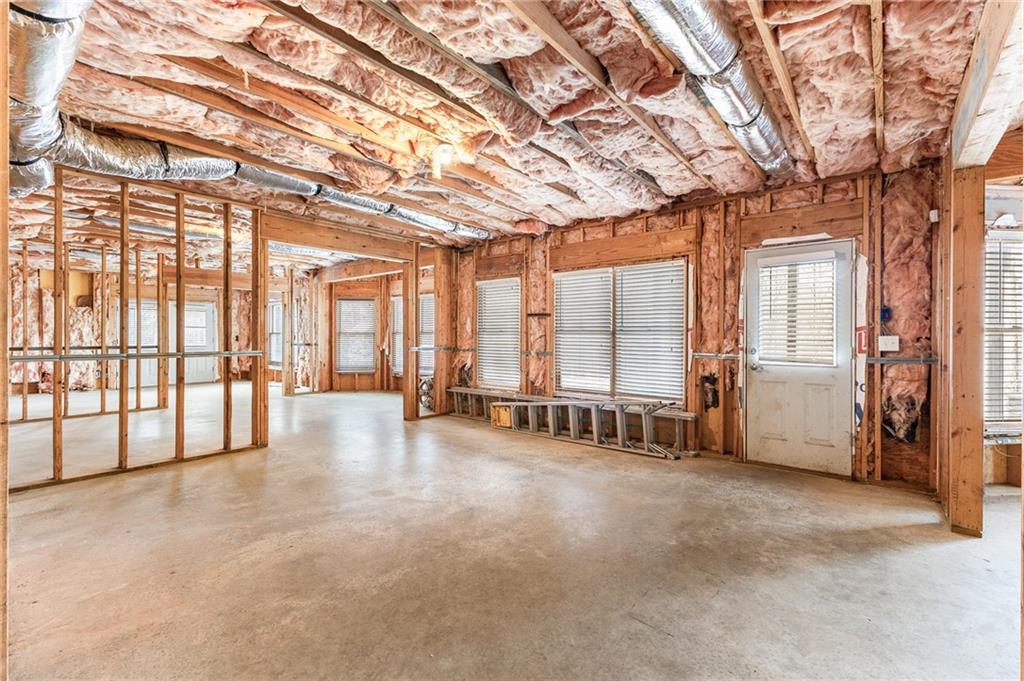 8805 Saddle Trail Ball Ground, GA 30107 - Photo 49 of 53 a view of an empty room with large windows