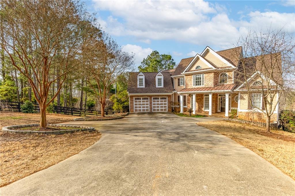 8805 Saddle Trail Ball Ground, GA 30107 - Photo 5 of 53 a front view of a house with a garden