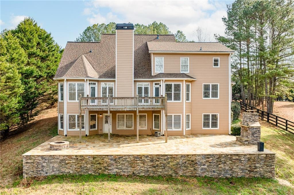 8805 Saddle Trail Ball Ground, GA 30107 - Photo 6 of 53 a front view of a house with a yard