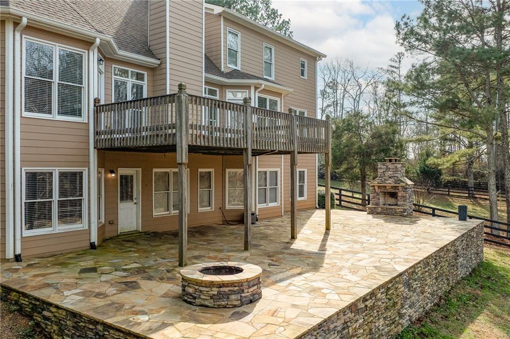 8805 Saddle Trail Ball Ground, GA 30107 - Photo 8 of 53 a view of a backyard with table and chairs and potted plants