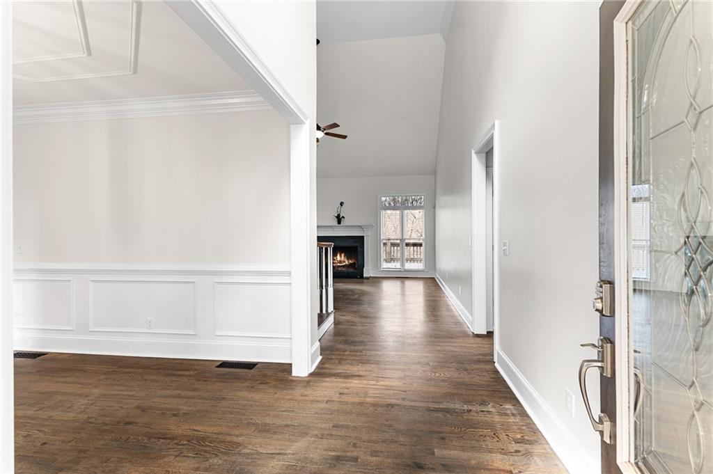 8805 Saddle Trail Ball Ground, GA 30107 - Photo 10 of 53 a view of a hallway with wooden floor and staircase