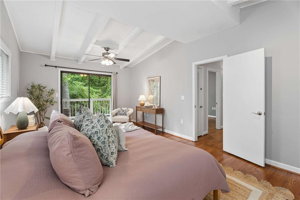 2200 Drew Valley Road Northeast Atlanta, GA 30319 - Photo 12 of 39 a spacious bedroom with a large bed and a chandelier
