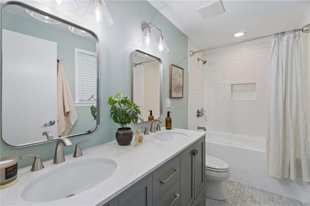 2200 Drew Valley Road Northeast Atlanta, GA 30319 - Photo 16 of 39 a bathroom with a double vanity sink toilet and shower