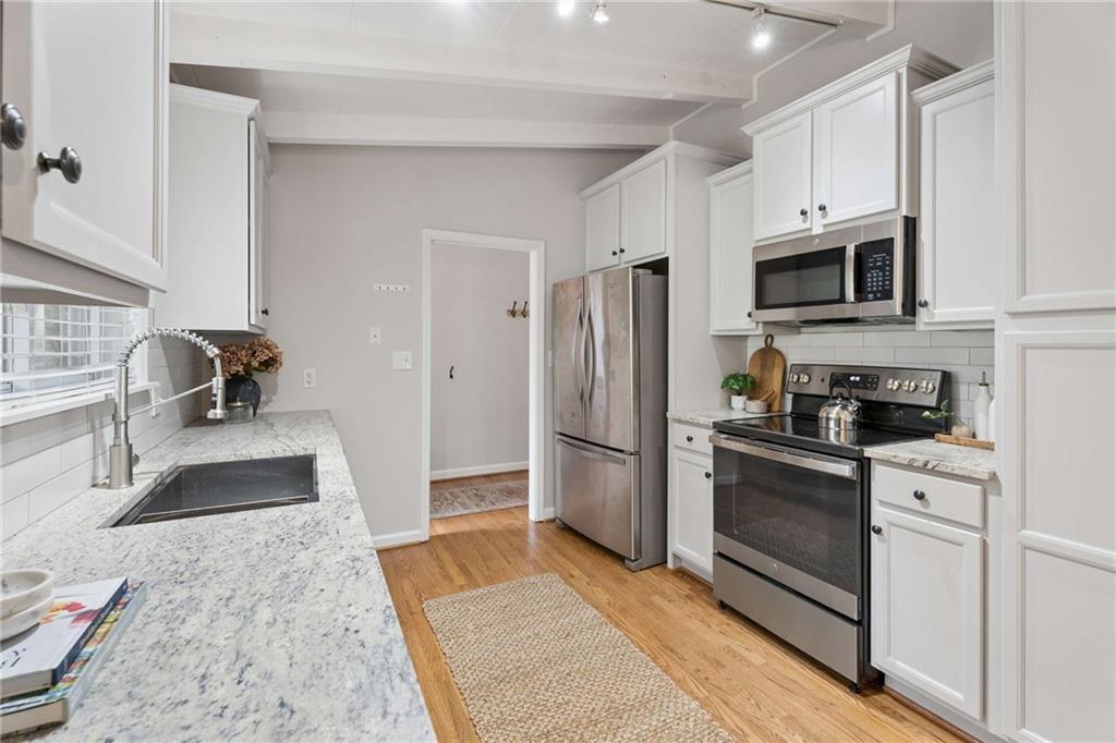 2200 Drew Valley Road Northeast Atlanta, GA 30319 - Photo 6 of 39 a kitchen with granite countertop a refrigerator stove and microwave