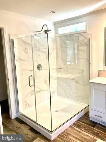a bathroom with a glass shower door