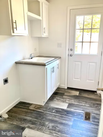 a kitchen with a sink cabinets and a window