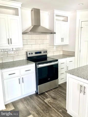 a kitchen with stainless steel appliances granite countertop a stove and a sink