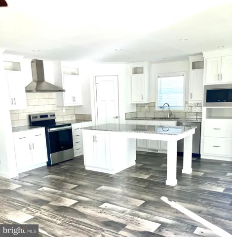 a living room with kitchen island granite countertop furniture and a fireplace