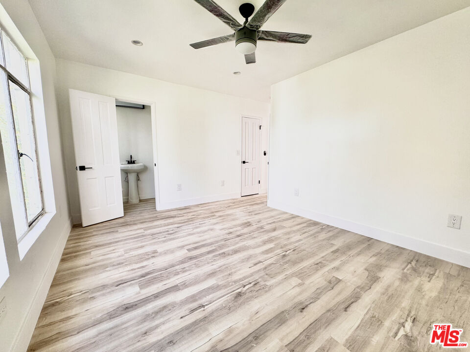 121 South Crescent Drive, Unit D Beverly Hills, CA 90212 - Photo 8 of 10 a view of a room with wooden floor and ceiling fan