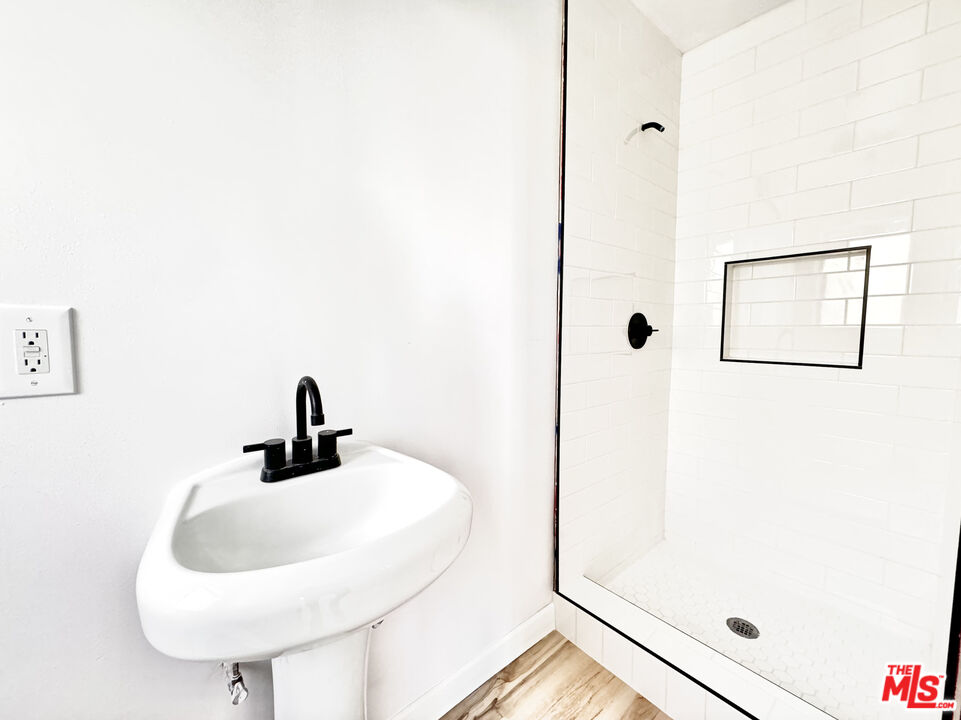 121 South Crescent Drive, Unit D Beverly Hills, CA 90212 - Photo 9 of 10 a bathroom with a sink and a mirror