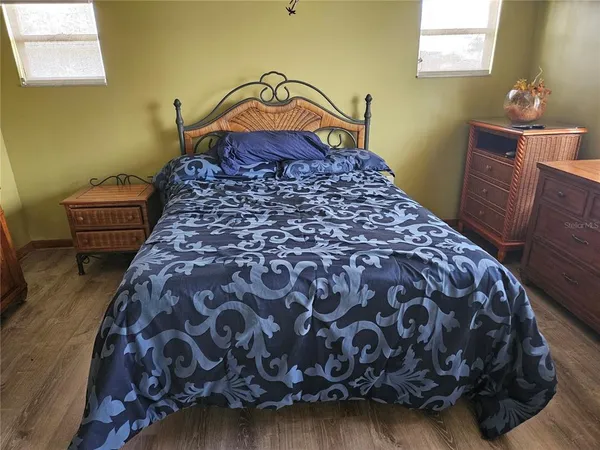 a bed sitting in a bedroom next to a window