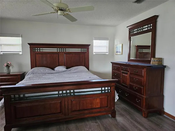 a bedroom with a bed and a dresser